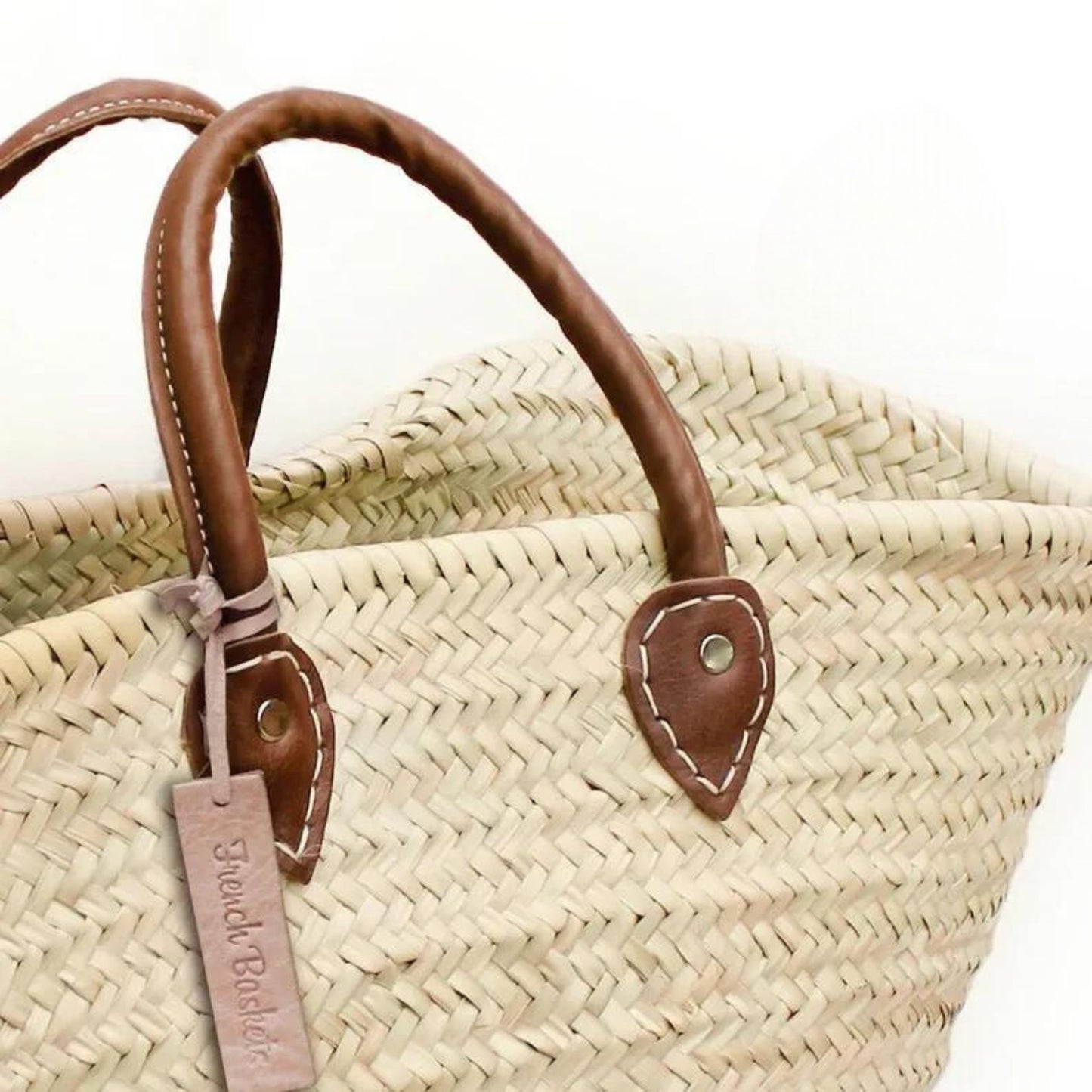 Close up of leather handles on French market basket