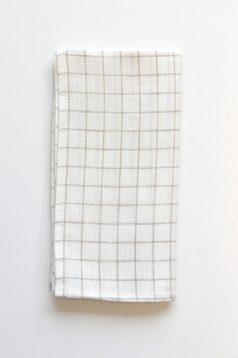 White windowpane napkin folded against white background