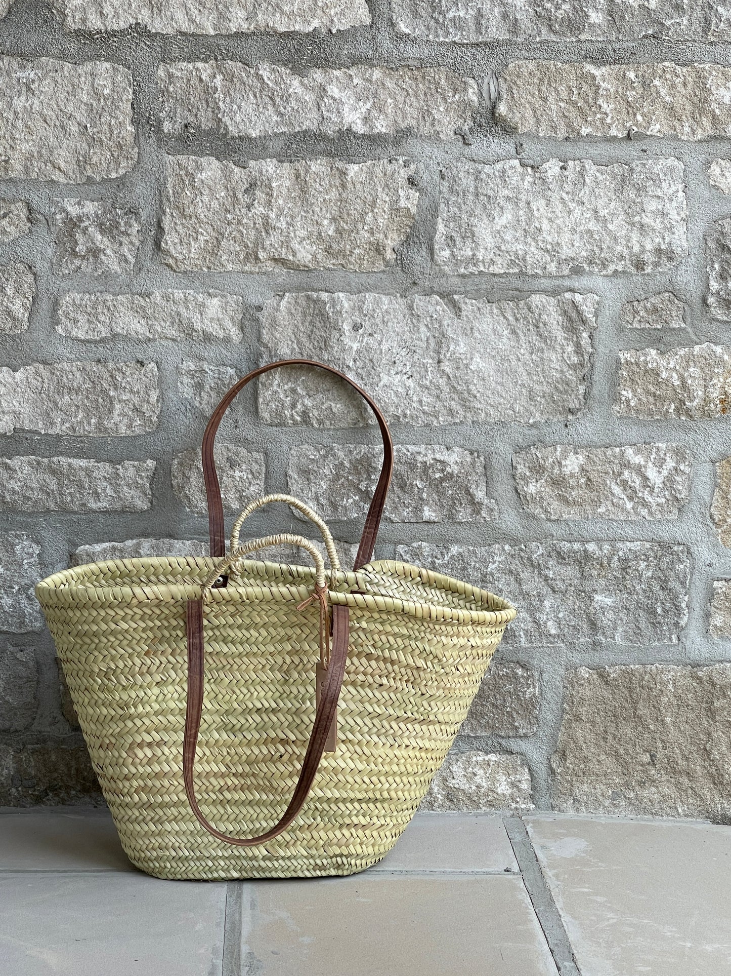 Double handle French market basket against stone wall | La Maison Baude