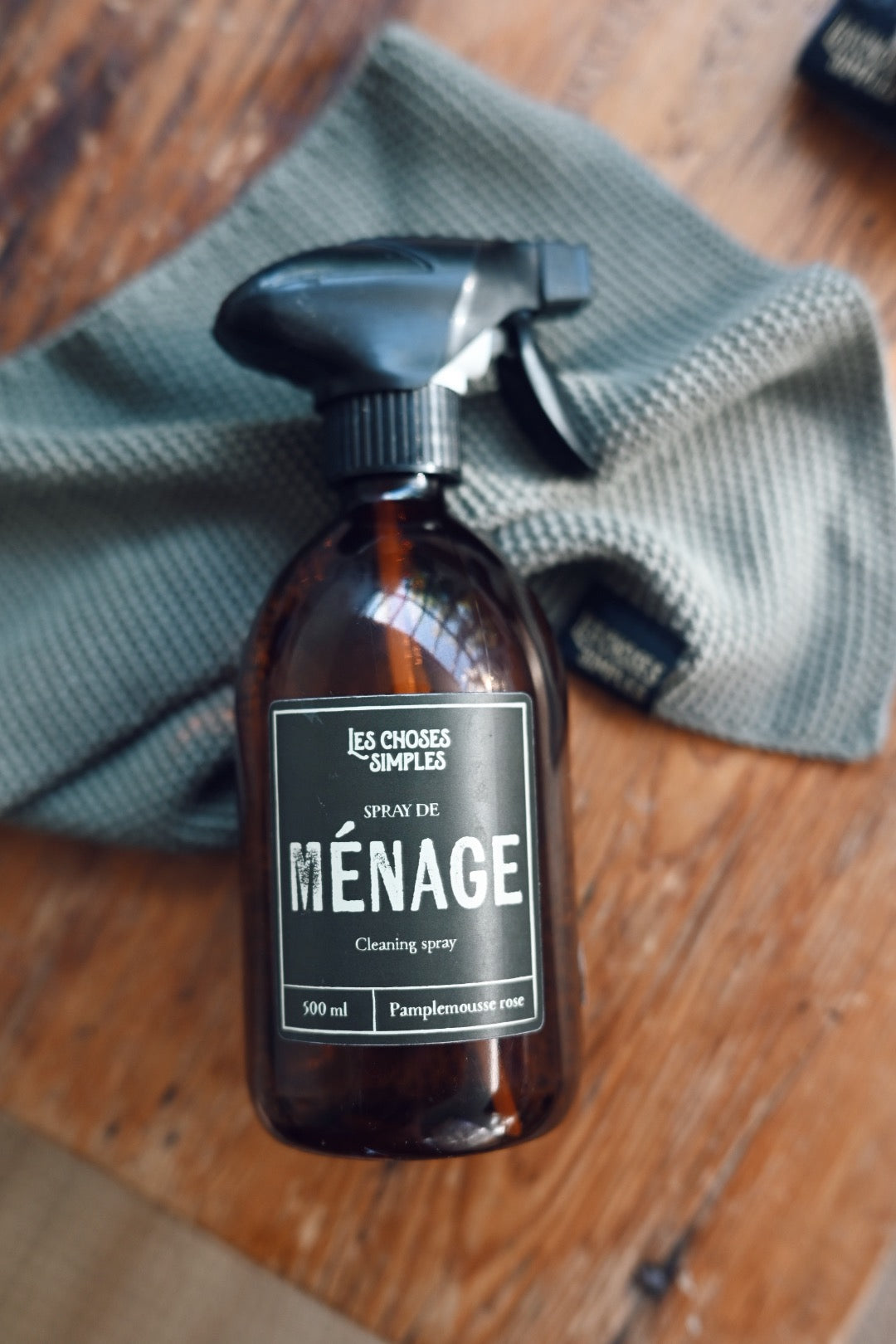 Menage Cleaning Spray with cotton towel on wooden table