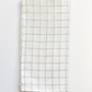 White windowpane napkin folded against white background