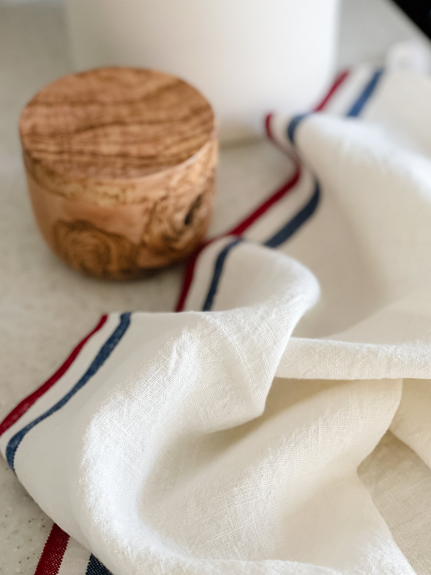 French Stripe Kitchen Towel on countertop beside olive wood salt cellar_LaMaisonBaude