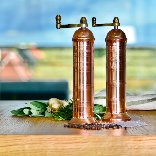 Artisan made Copper salt and pepper grinders on table